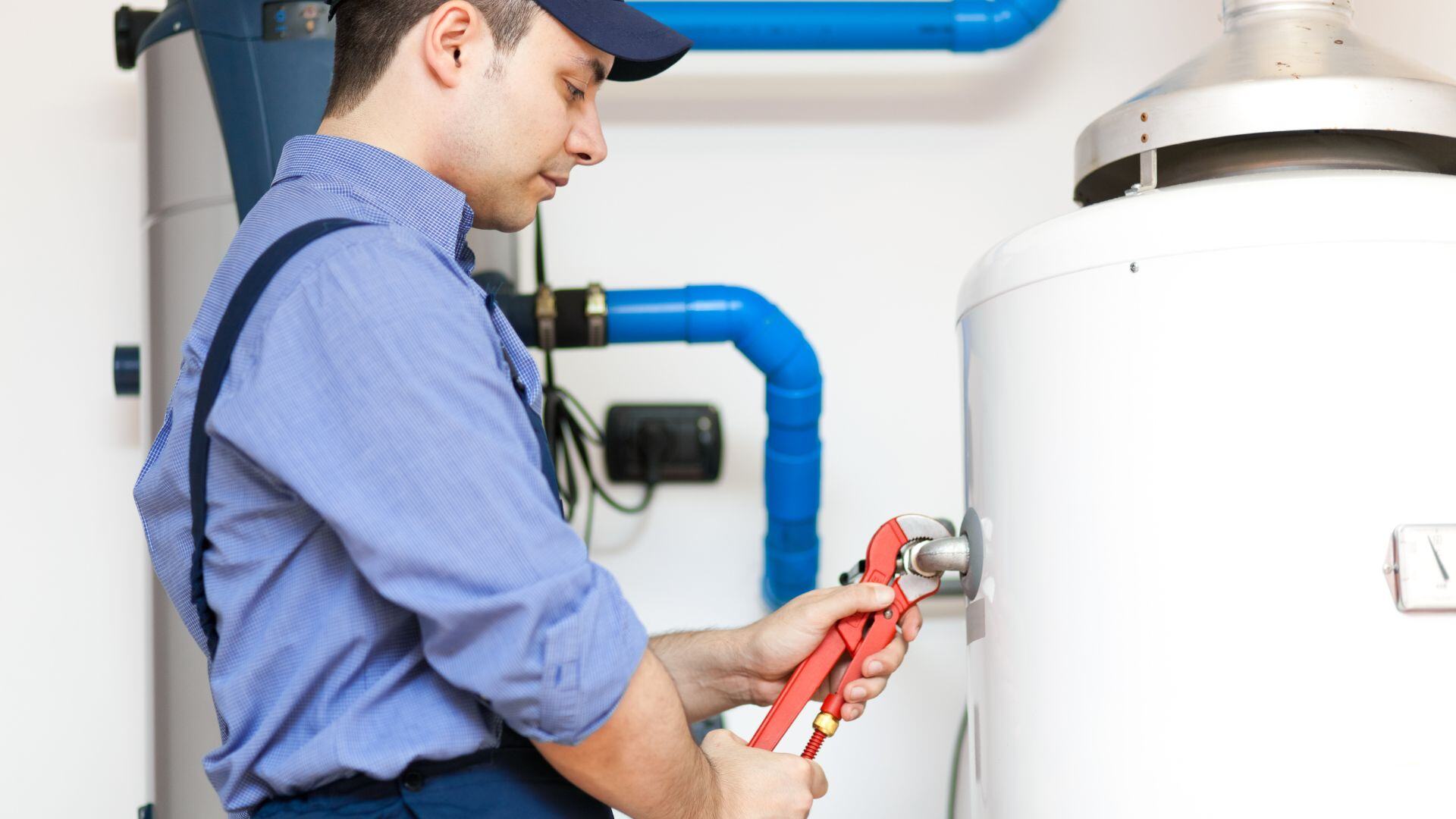 A plumber working on a water heater